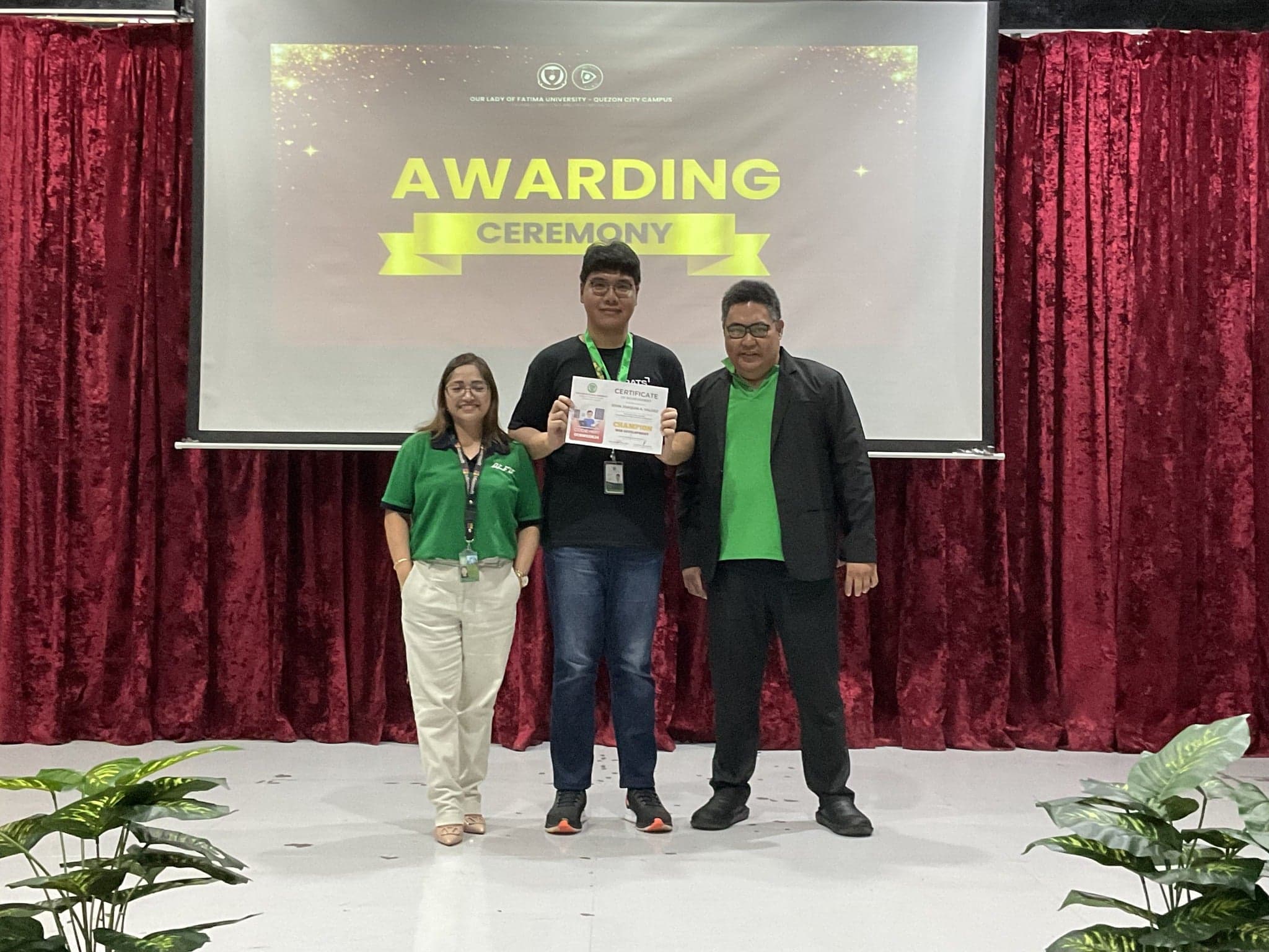 Champion award ceremony: Joaquin Valdez receiving Web Development championship award at CCS Week 2024 with professors Ma'am Chua and Sir Arfel at Our Lady of Fatima University Quezon City Campus