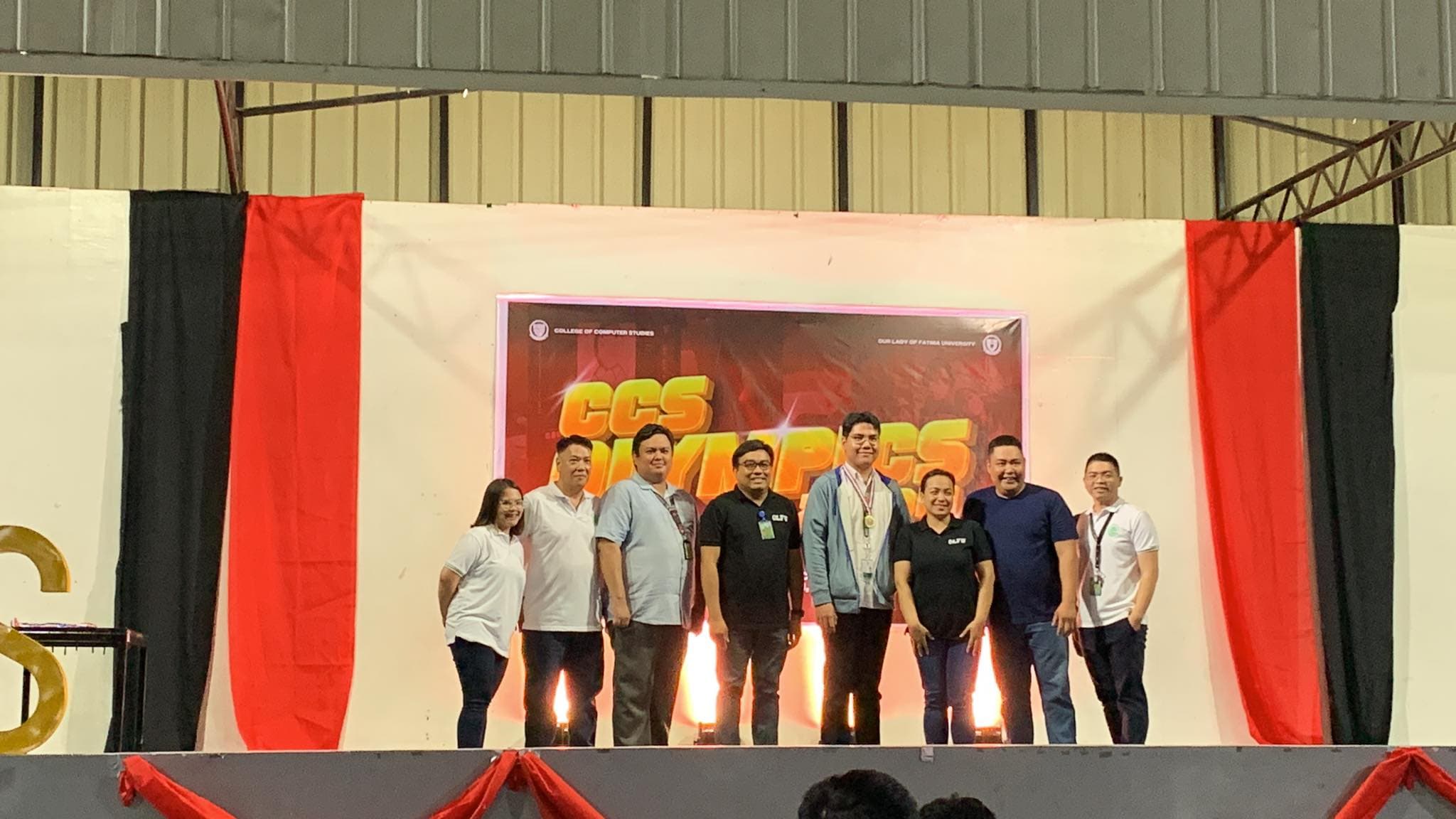 Champion award ceremony group photo: Joaquin Valdez receiving Web Development championship trophy at CCS Intercampus IT Olympics 2024 with OLFU Quezon City and Antipolo Campus computer science professors at Antipolo Campus